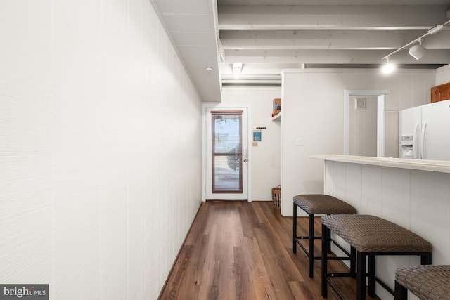 kitchen featuring track lighting, hardwood / wood-style flooring, and white refrigerator with ice dispenser