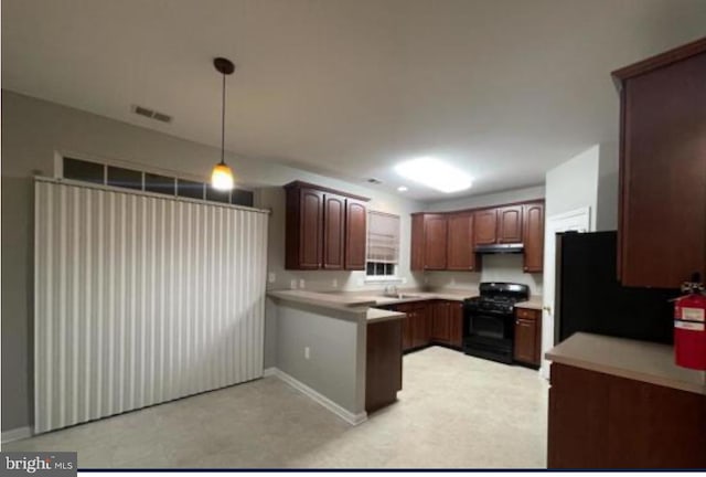 kitchen featuring black appliances, kitchen peninsula, and hanging light fixtures