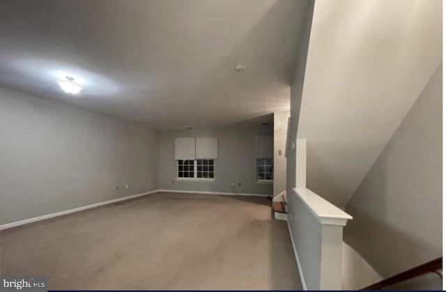 unfurnished living room with light colored carpet