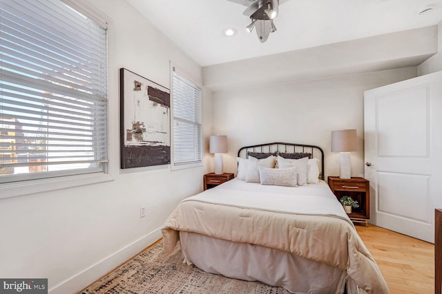 bedroom with ceiling fan and light hardwood / wood-style floors