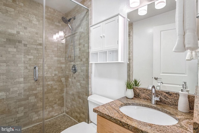 bathroom featuring vanity, toilet, and walk in shower