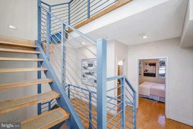 staircase with hardwood / wood-style flooring