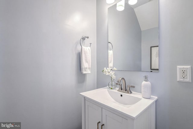 bathroom with vanity and vaulted ceiling