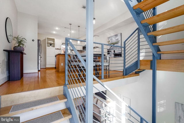 stairs with hardwood / wood-style flooring