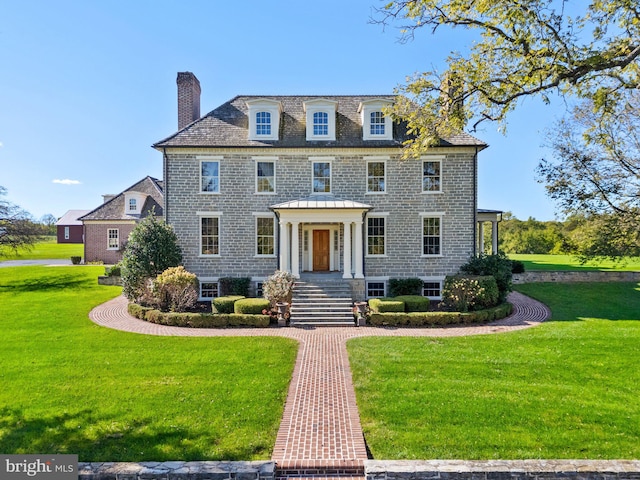 colonial-style house with a front lawn