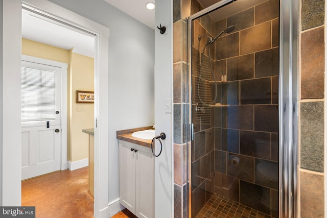 bathroom featuring vanity and a tile shower