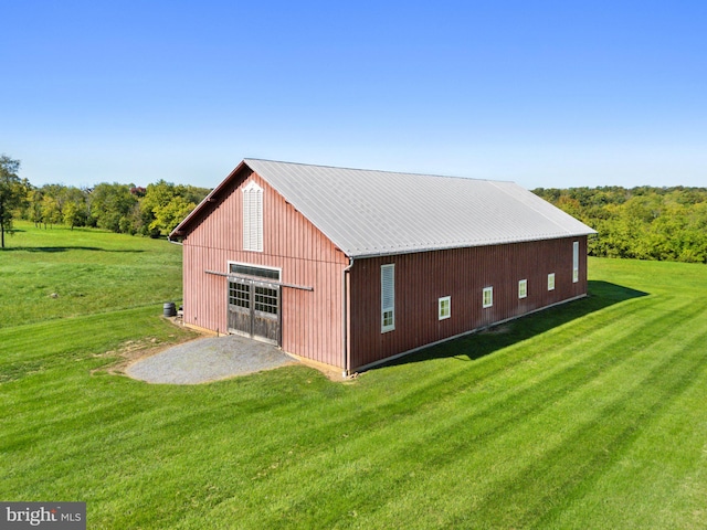 view of home's exterior featuring a lawn and an outbuilding