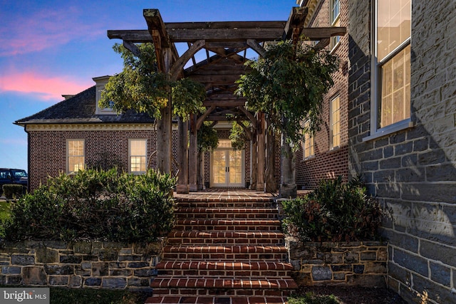 view of exterior entry at dusk