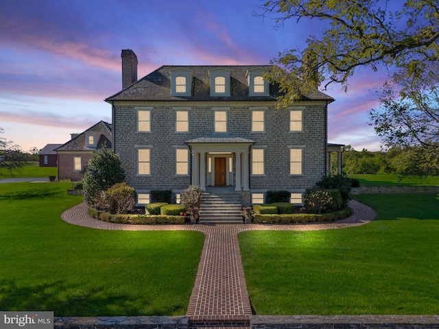 colonial inspired home featuring a lawn