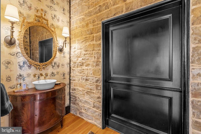 bathroom with hardwood / wood-style floors and vanity