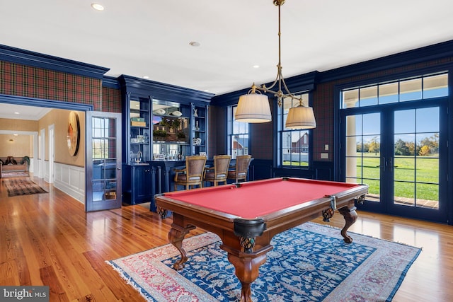 playroom featuring bar area, french doors, crown molding, light hardwood / wood-style flooring, and pool table