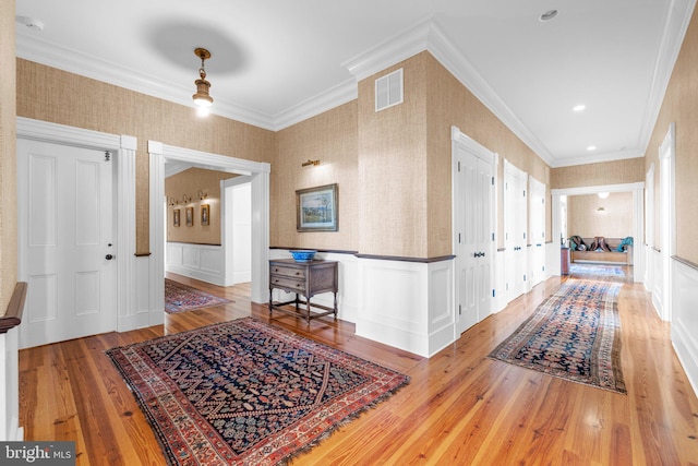 corridor featuring hardwood / wood-style floors and ornamental molding