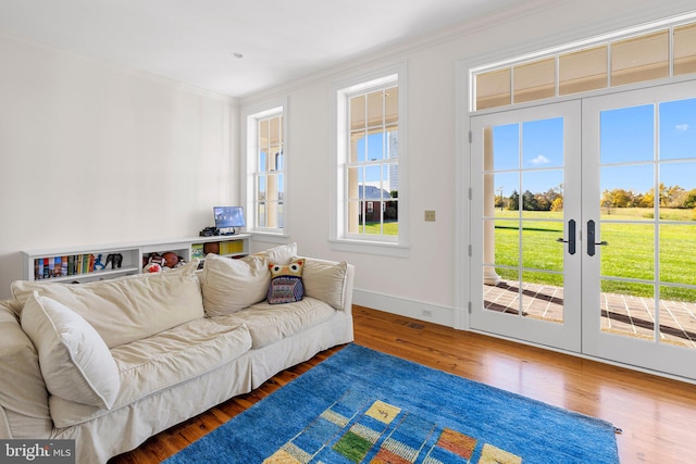 living room featuring crown molding, french doors, and dark hardwood / wood-style floors