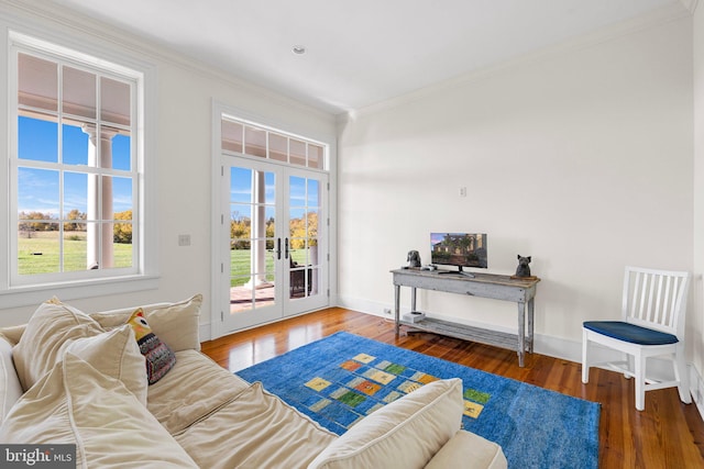 living room with crown molding, french doors, and hardwood / wood-style floors