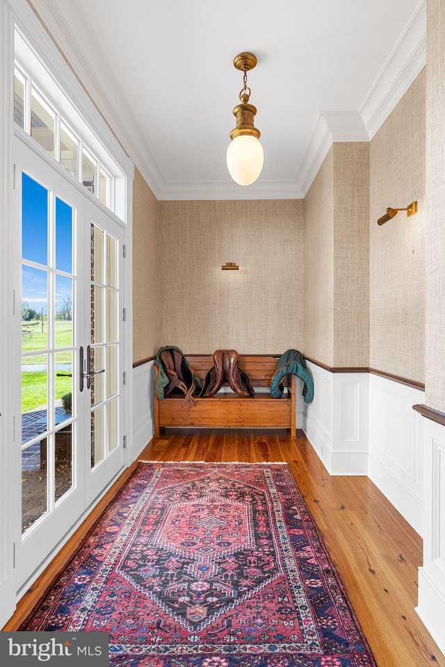 sitting room featuring french doors, ornamental molding, and hardwood / wood-style flooring