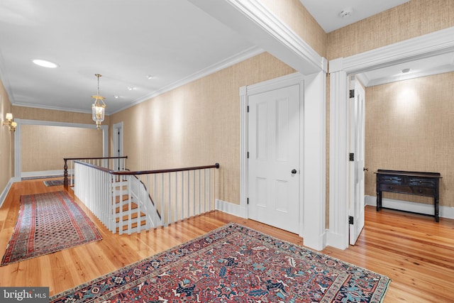 hallway featuring hardwood / wood-style flooring and ornamental molding