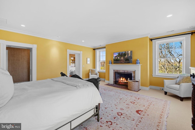 bedroom with light colored carpet, ornamental molding, and a fireplace