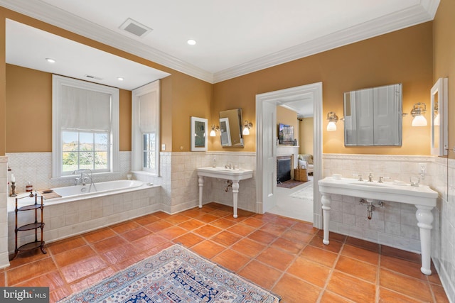 bathroom with tiled bath, tile patterned floors, and crown molding