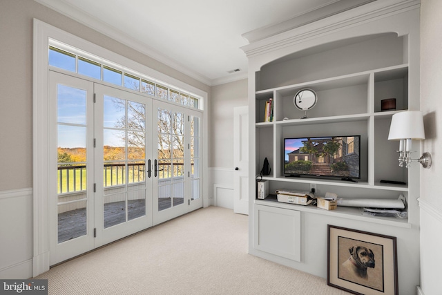 interior space featuring crown molding, light carpet, and french doors