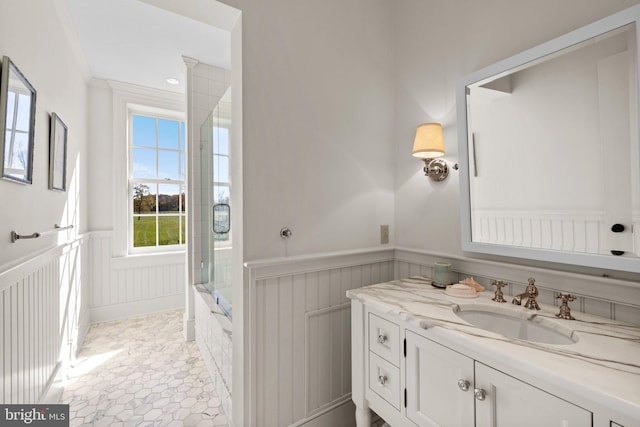 bathroom with tile patterned floors, vanity, ornamental molding, and walk in shower