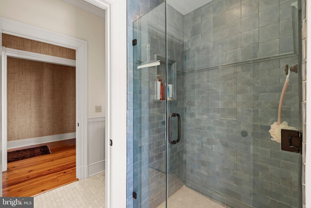 bathroom featuring hardwood / wood-style floors and a shower with shower door