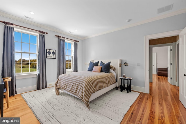 bedroom featuring hardwood / wood-style flooring and ornamental molding