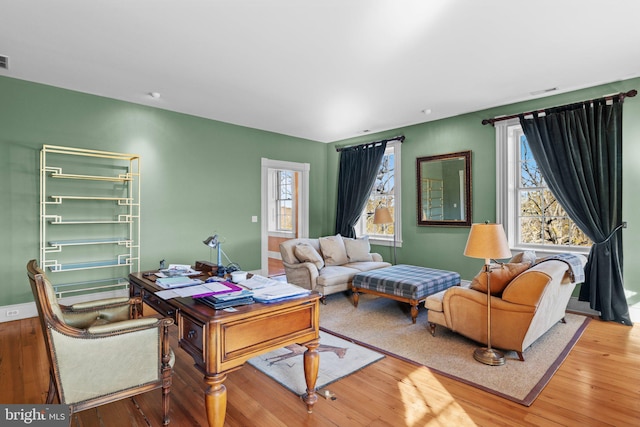 living room featuring hardwood / wood-style flooring and a healthy amount of sunlight