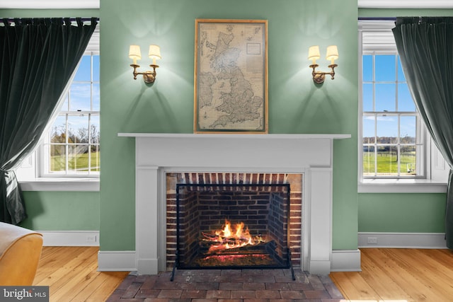 room details with hardwood / wood-style flooring and a brick fireplace