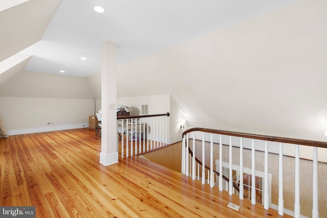 additional living space featuring hardwood / wood-style floors and lofted ceiling