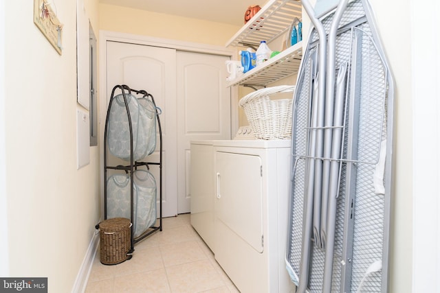 laundry room featuring washing machine and dryer and light tile patterned floors