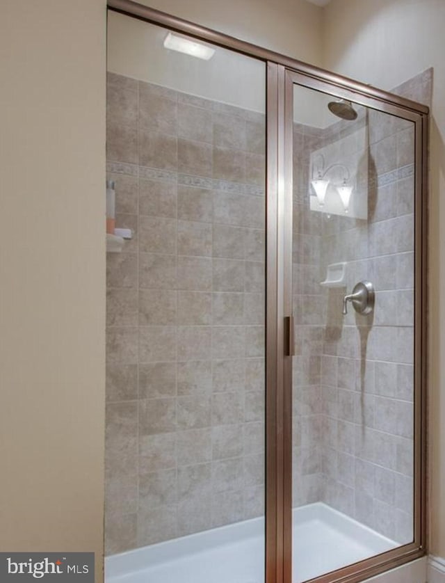 bathroom with a shower with shower door