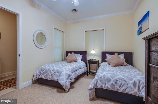 carpeted bedroom featuring ceiling fan and crown molding