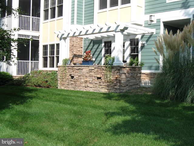 exterior space with a pergola and a yard