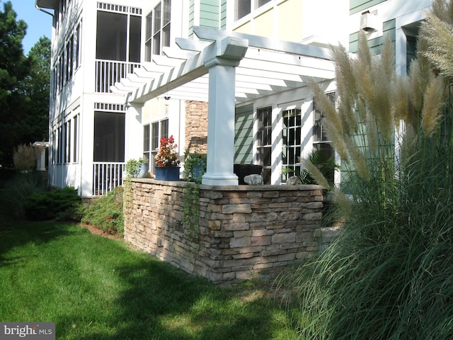 view of side of home featuring a pergola