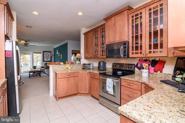 kitchen featuring light stone counters, crown molding, appliances with stainless steel finishes, kitchen peninsula, and ceiling fan