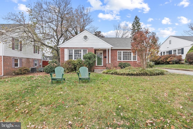 view of front of home with cooling unit and a front yard