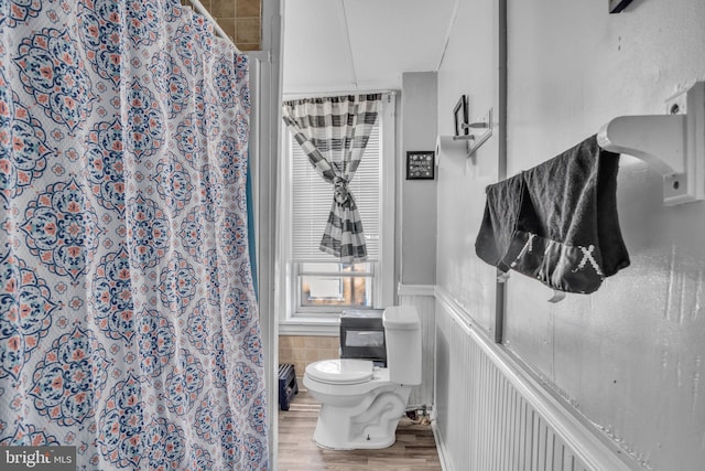 bathroom featuring toilet, a shower with shower curtain, and hardwood / wood-style flooring