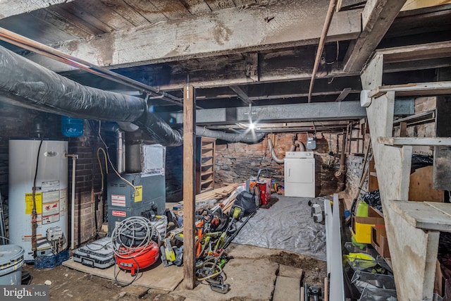 basement featuring gas water heater, heating unit, and washer / clothes dryer