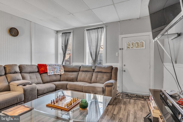 living room featuring a paneled ceiling and wood-type flooring