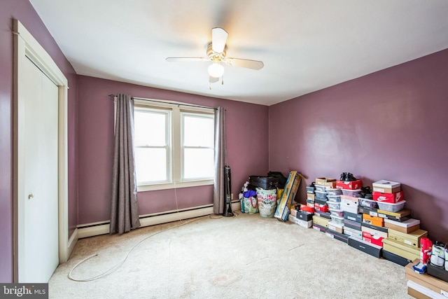 interior space featuring carpet floors, a baseboard heating unit, and ceiling fan