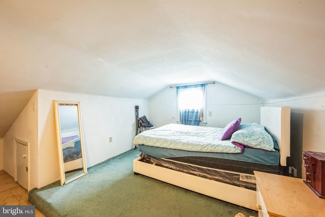 carpeted bedroom with vaulted ceiling