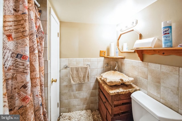 bathroom featuring tile walls, toilet, vanity, and a shower with shower curtain