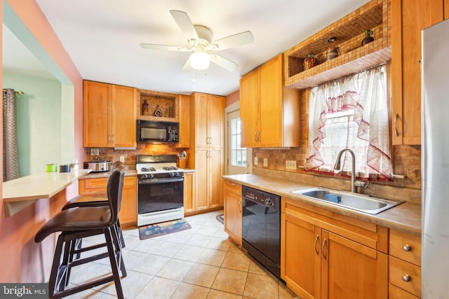 kitchen with black appliances, sink, ceiling fan, light tile patterned floors, and tasteful backsplash