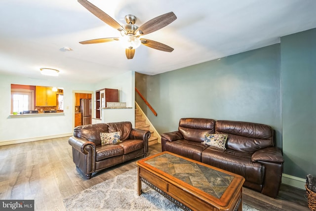 living room featuring ceiling fan and wood-type flooring