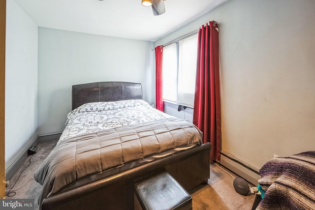 carpeted bedroom with ceiling fan and a baseboard radiator