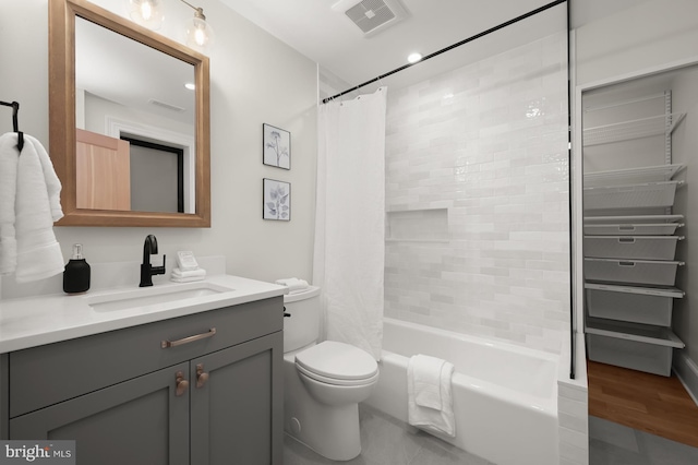 full bathroom featuring hardwood / wood-style flooring, toilet, vanity, and shower / bathtub combination with curtain