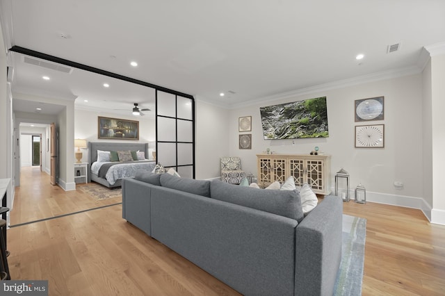 living room with light wood-type flooring, ceiling fan, and crown molding