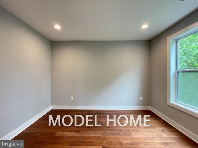 unfurnished room featuring hardwood / wood-style flooring and a healthy amount of sunlight