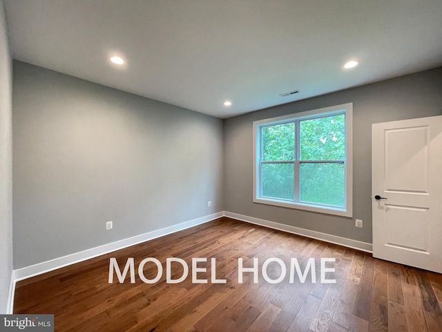 unfurnished room featuring hardwood / wood-style floors