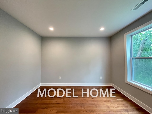 unfurnished room featuring hardwood / wood-style flooring